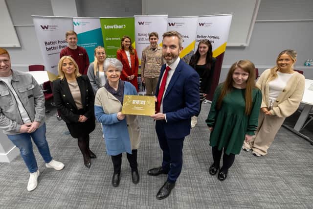 Staff and young people at Wheatley Group with Chair of Wheatley Group  Jo Armstrong and Group Chief Executive Steven Henderson holding IIYP Gold Award.