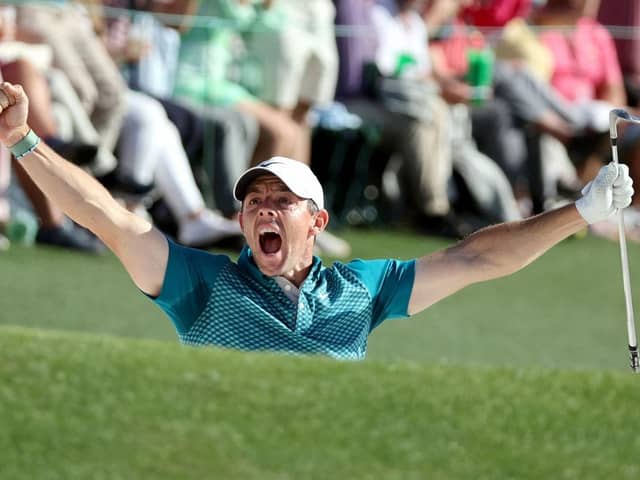 Rory McIlroy celebrates after holing out from a bunker on the 72nd hole in last year's Masters to finish second behind Scottie Scheffler. Picture: Gregory Shamus/Getty Images.