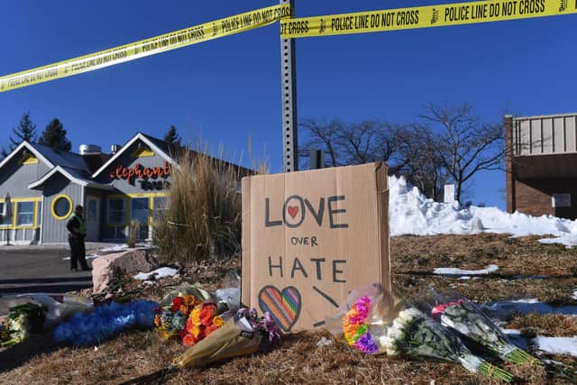 Bouquets of flowers and a sign reading "Love Over Hate" are left near Club Q, an LGBTQ nightclub in Colorado Springs, Colorado, on November 20, 2022. - At least five people were killed and 18 wounded in a (Photo by JASON CONNOLLY/AFP via Getty Images)