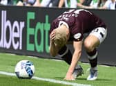 Alex Cochrane of Hearts is hit by objects thrown from the Hibs support during the Edinburgh derby at Easter Road. (Photo by Rob Casey / SNS Group)