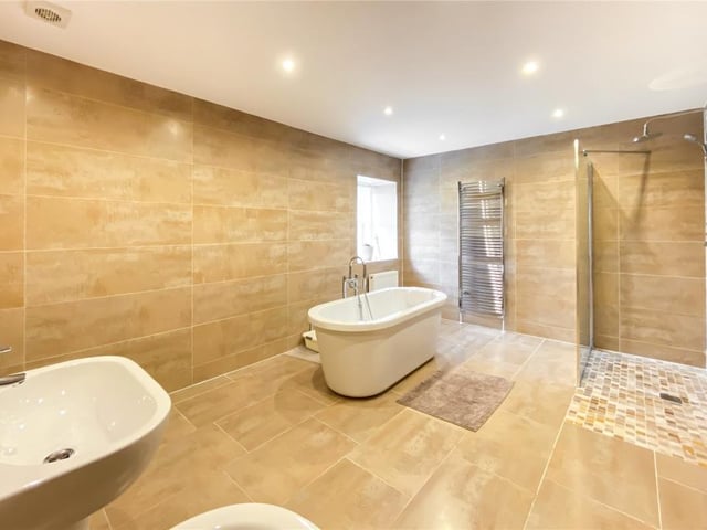 The family bathroom has a freestanding bath and separate shower.