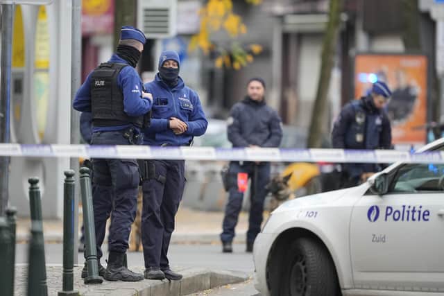 Belgian Police stand behind a cordoned off area close to where a suspected Tunisian extremist has been shot dead hours after a manhunt looking for him. Picture: AP Photo/Martin Meissner