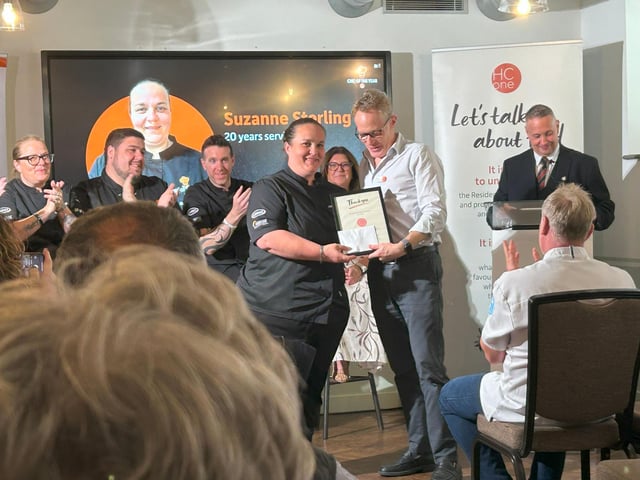 Suzanne Stirling, Group Development Chef at HC-One being presented with her 20 year long service award by James Tugendhat, Chief Executive Officer at HC-One at the HC-One Chef of the Year Competition 2025