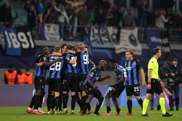 Players of Club Brugge celebrate after victory in the UEFA Champions League Group A match against RB Leipzig.
