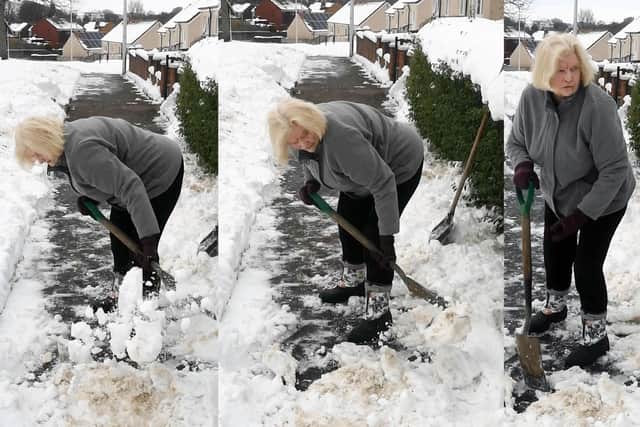 85-years-old Isabel Nicholson clearing snow outside her home in Redding.
