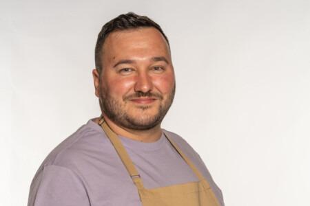 Janusz grew up in Poland and moved to the UK 10 years ago. He is now living on the southeast coast with his boyfriend, Simon, and their sausage dog, Nigel. Apart from baking, Janusz’s passions include internet culture, watching drag (he even bought his boyfriend a statue of Ru Paul) and collecting movie props. He was inspired to bake by his mother, who always baked on a Saturday; a tradition Janusz continued when he moved away from home to go to university. He describes his baking style as ‘cartoon-like, colourful and camp’, and loves working Polish ingredients into British staples. His favourite flavours are ginger and chocolate.
