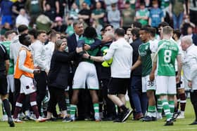 Hibs' Rocky Bushiri clashes with Hearts players at full time of last weekend's derby.