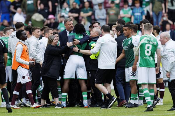 Hibs' Rocky Bushiri clashes with Hearts players at full time of last weekend's derby.