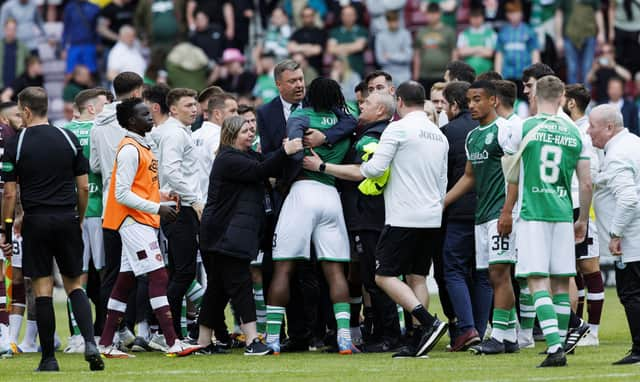 Hibs' Rocky Bushiri clashes with Hearts players at full time of last weekend's derby.