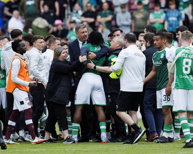 Hibs' Rocky Bushiri clashes with Hearts players at full time of last weekend's derby.