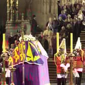 People file past the coffin of Britain's Queen Elizabeth The Queen Mother,  in Westminster Hall, London, where she is lying in state before her funeral.