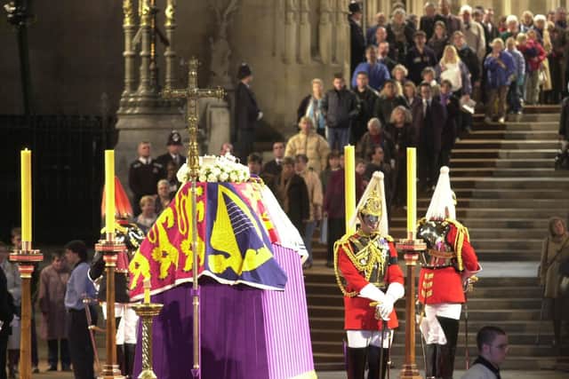 People file past the coffin of Britain's Queen Elizabeth The Queen Mother,  in Westminster Hall, London, where she is lying in state before her funeral.