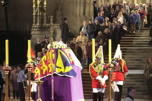 People file past the coffin of Britain's Queen Elizabeth The Queen Mother,  in Westminster Hall, London, where she is lying in state before her funeral.