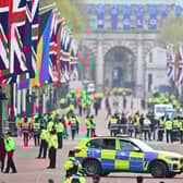 Police officers and security employees gather on The Mall ahead of the Coronation of King Charles III and Queen Camilla