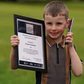 Four-year-old Hanlon Stevenson receives a Chief Constable's Bravery and Excellence Award from Sir Iain Livingstone during a ceremony at the Police Scotland headquarters in Tulliallan, Kincardine, Fife. Picture: Andrew Milligan/PA Wire