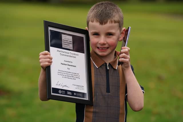 Four-year-old Hanlon Stevenson receives a Chief Constable's Bravery and Excellence Award from Sir Iain Livingstone during a ceremony at the Police Scotland headquarters in Tulliallan, Kincardine, Fife. Picture: Andrew Milligan/PA Wire