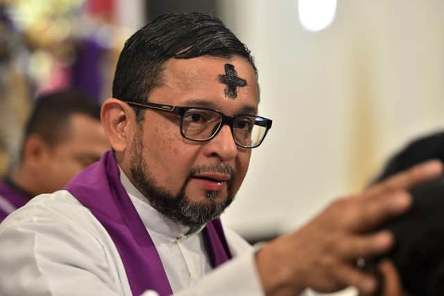 A priest will officiate Ash Wednesday by rubbing ashes in a cross-shape onto the head of church-goers, signifying the beginning of Lent (Picture: Getty Images)
