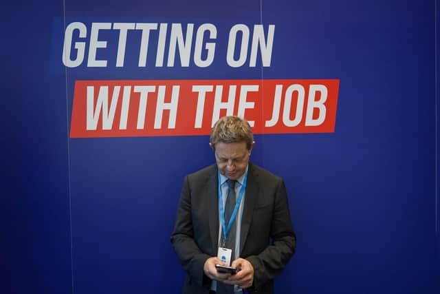 A man checks his phone on the first day of the Conservative Party Conference at Manchester Central Convention Complex. Picture: Ian Forsyth/Getty Images