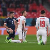 England and Scotland players take a knee in protest against racism ahead of the Euro 2020 match at Wembley Stadium in London (Picture: Laurence Griffiths/Getty Images)