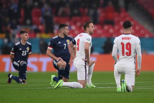 England and Scotland players take a knee in protest against racism ahead of the Euro 2020 match at Wembley Stadium in London (Picture: Laurence Griffiths/Getty Images)