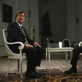 In this photo released by Sputnik news agency, Russian president Vladimir Putin (right) and former Fox News host Tucker Carlson prepare for an interview at the Kremlin in Moscow. Picture: Gavriil Grigorov, Sputnik, Kremlin Pool Photo via AP