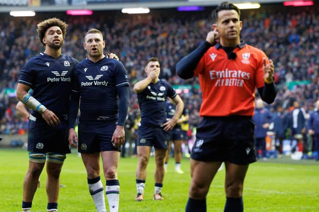 Andy Christie (left) and Finn Russell look on as referee Nic Berry consults the TMO during the Guinness Six Nations match between Scotland and France at Murrayfield. World Rugby wants to speed up the TMO process. (Photo by Ross Parker / SNS Group)