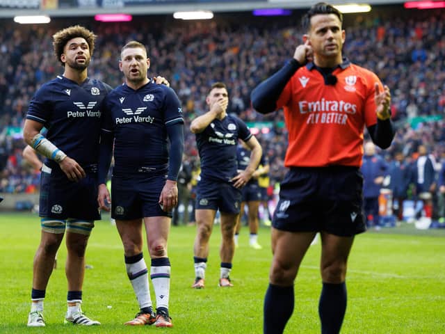Andy Christie (left) and Finn Russell look on as referee Nic Berry consults the TMO during the Guinness Six Nations match between Scotland and France at Murrayfield. World Rugby wants to speed up the TMO process. (Photo by Ross Parker / SNS Group)