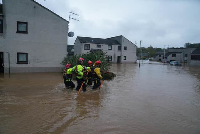 Emergency workers wade through flood water in Brechin as Storm Babet batters the country. The Scottish Fire and Rescue Service has raised serious concerns about its ability to meet such extreme weather events given a surge in incidents - and a loss of staff and budget. PIC: Andrew Milligan/PA Wire