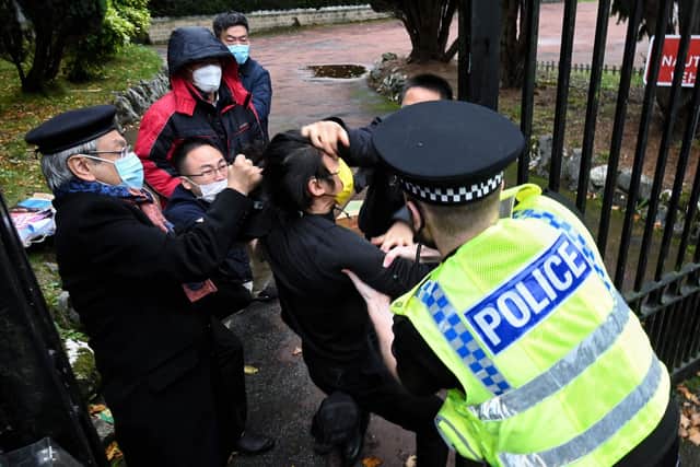 This image from The Chaser News shows an incident involving a scuffle between a Hong Kong pro-democracy protester (centre) and Chinese consulate staff, as a British police officer attempts to intervene, during a demonstration outside the consulate in Manchester. Picture: Matthew Leung/The Chaser News/AFP via Getty Images