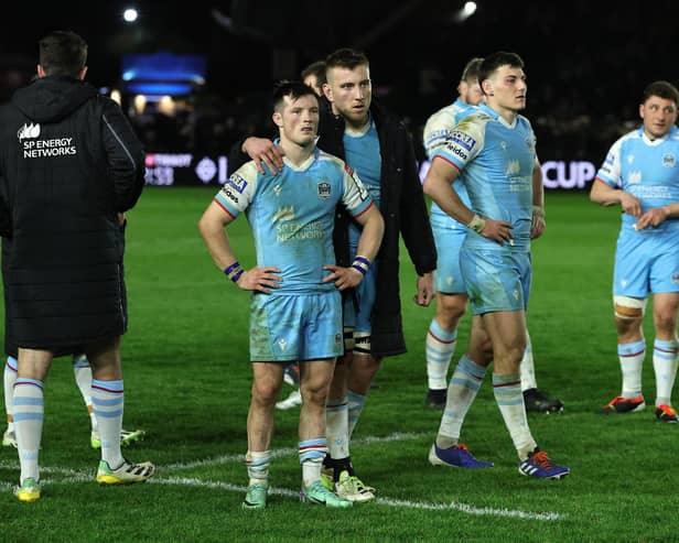 George Horne of Glasgow Warriors is consoled after their defeat by Harlequins.