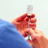 A vial of the Moderna Covid-19 vaccine is prepared at the Madejski Stadium in Reading (Photo by Steve Parsons / POOL / AFP).