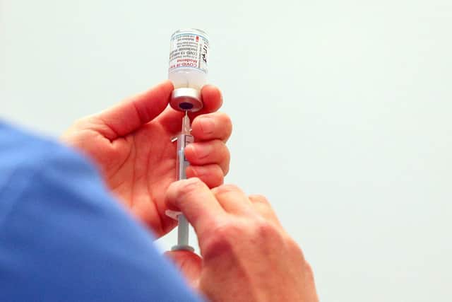 A vial of the Moderna Covid-19 vaccine is prepared at the Madejski Stadium in Reading (Photo by Steve Parsons / POOL / AFP).