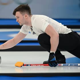 Britain's Bruce Mouat in action at the Beijing 2022 Winter Olympic Games curling competition (Photo by LILLIAN SUWANRUMPHA/AFP via Getty Images)