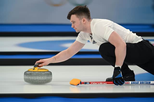 Britain's Bruce Mouat in action at the Beijing 2022 Winter Olympic Games curling competition (Photo by LILLIAN SUWANRUMPHA/AFP via Getty Images)