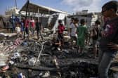 Palestinians inspect the damage at a tent area in the courtyard of Al Aqsa Martyrs hospital, hit by an Israeli bombardment on Deir al-Balah. Picture: AP Photo/Abdel Kareem Hana