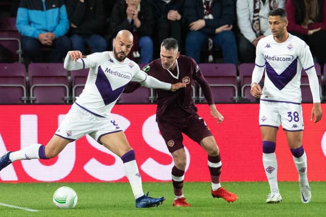 Sofyan Amrabat and Michael Smith in action during a UEFA Europa Conference League match between Heart of Midlothian and Fiorentina at Tynecastle, on October 06, 2022, in Edinburgh, Scotland. (Photo by Ross Parker / SNS Group)