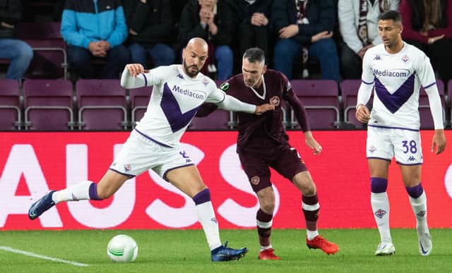 Sofyan Amrabat and Michael Smith in action during a UEFA Europa Conference League match between Heart of Midlothian and Fiorentina at Tynecastle, on October 06, 2022, in Edinburgh, Scotland. (Photo by Ross Parker / SNS Group)