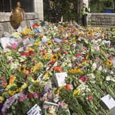 Floral tributes left at the gates of Balmoral Castle on The Queen's final day at her beloved home in Scotland. PIC: Contributed.