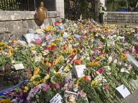 Floral tributes left at the gates of Balmoral Castle on The Queen's final day at her beloved home in Scotland. PIC: Contributed.