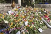 Floral tributes left at the gates of Balmoral Castle on The Queen's final day at her beloved home in Scotland. PIC: Contributed.