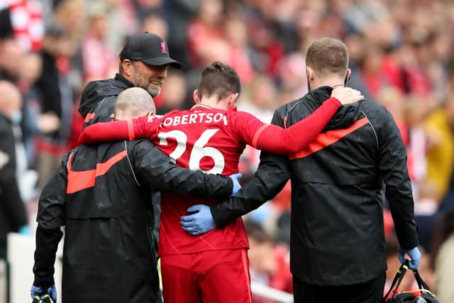 Andy Robertson limps off the pitch during Liverpool's friendly against Atletic Bilbao.