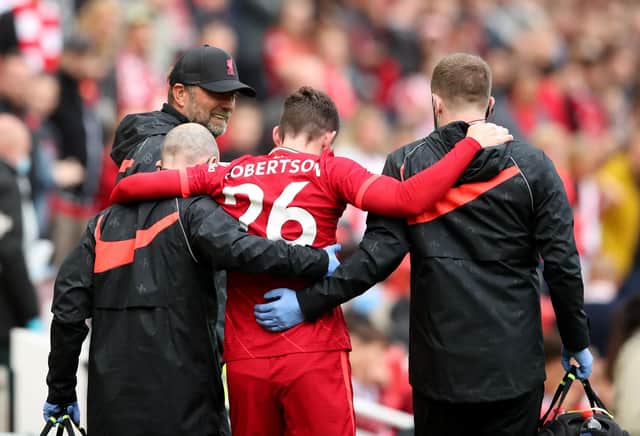 Andy Robertson limps off the pitch during Liverpool's friendly against Atletic Bilbao.