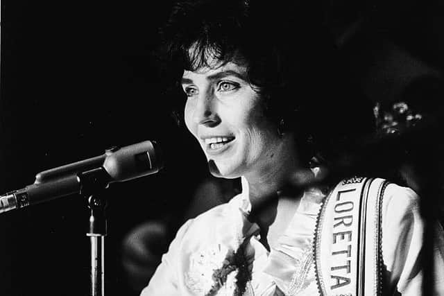 Loretta Lynn performs on stage at the Grand Ole Opry in the1960s. (Photo by Hulton Archive/Getty Images)