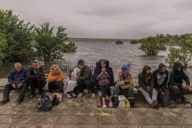 People wait for a transfer on a pontoon in a flooded area as the result of the Kakhovka dam destruction in Afanasiivka village, Mykolaiv region, Ukraine. The entrances to Afanasiivka, an island-located village with over 300 residents, were completely flooded, and now people can go in and out of the village only by boats or pontoons. Picture: Getty Images