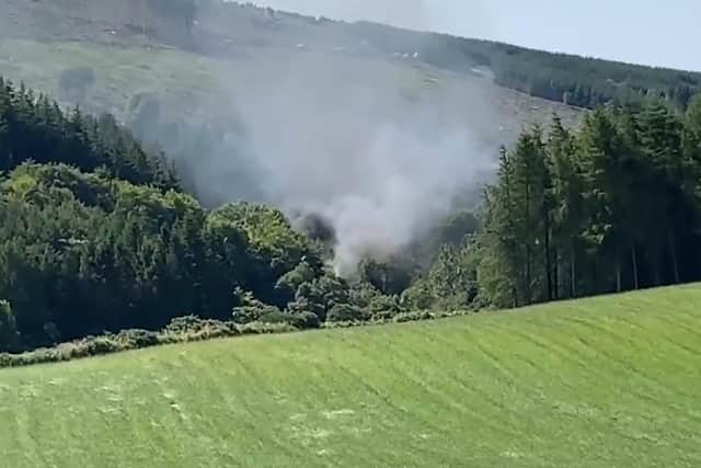 Smoke billowing from the train on the track in the countryside near Stonehaven, Aberdeenshire . Picture: BBC Scotland/PA Wire