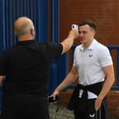 George Edmundson has his temperature tested as he arrives at Ibrox before Rangers' Premiership match against St Mirren earlier this season. The defender has now been suspended along with team-mate Jordan Jones for breaching the club's Covid-19 protocols at the weekend. (Craig Foy / SNS Group)