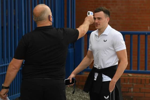 George Edmundson has his temperature tested as he arrives at Ibrox before Rangers' Premiership match against St Mirren earlier this season. The defender has now been suspended along with team-mate Jordan Jones for breaching the club's Covid-19 protocols at the weekend. (Craig Foy / SNS Group)