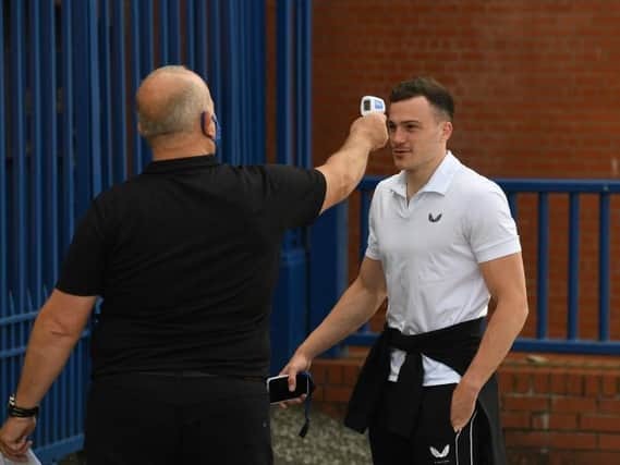 George Edmundson has his temperature tested as he arrives at Ibrox before Rangers' Premiership match against St Mirren earlier this season. The defender has now been suspended along with team-mate Jordan Jones for breaching the club's Covid-19 protocols at the weekend. (Craig Foy / SNS Group)
