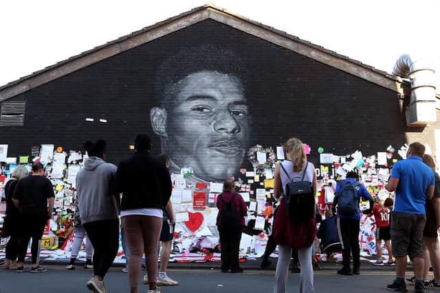A mural of England footballer Marcus Rashford, repaired after it was vandalised, has been covered with messages of goodwill and support (Picture: Charlotte Tattersall/Getty Images)