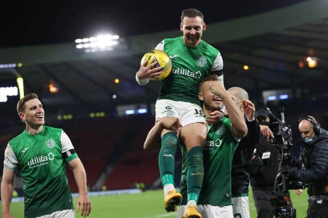 Hibs' hat-trick hero Martin Boyle clutches the match ball as he is held aloft after the 3-1 win over Rangers at Hampden. (Photo by Alan Harvey / SNS Group)